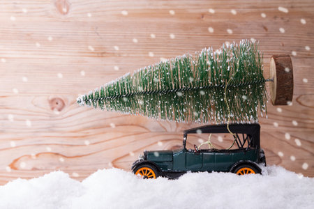 car on snow with christmas tree, merry christmasの写真素材
