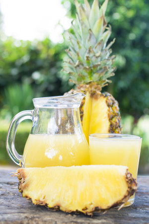 glass jar of pineapple juice with fresh fruitsの写真素材