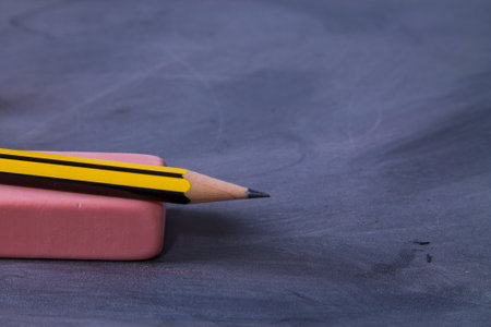 pencil and eraser on blackboard, concept back to schoolの写真素材