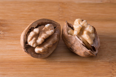 dried fruits, open nuts on wood