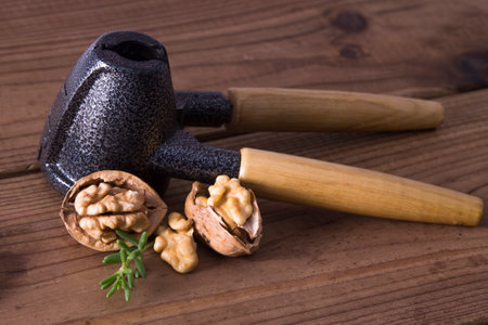nutcracker and open walnuts on woodの写真素材