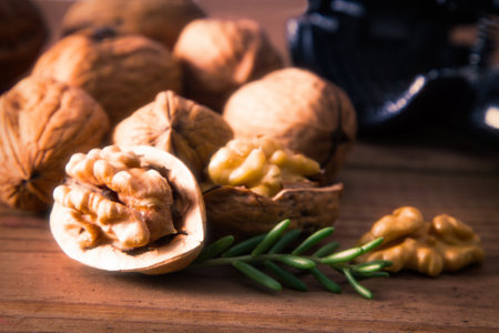 open walnuts and nutcracker on woodの写真素材