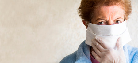 portrait of senior woman with disposable medical mask. Safety in public places during  outbreak.の写真素材