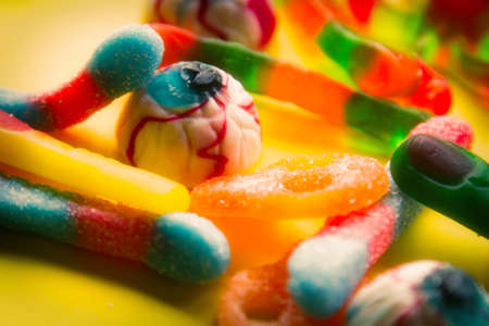 halloween candies seen close up on yellow backgroundの写真素材