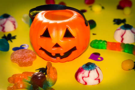 halloween candies seen close up on yellow backgroundの写真素材