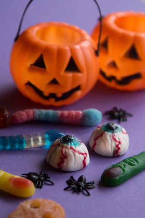 halloween candies with orange pumpkin in the backgroundの写真素材