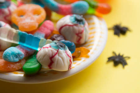 halloween candies seen close up on yellow backgroundの写真素材