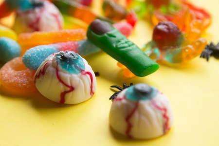 halloween candies seen close up on yellow backgroundの写真素材