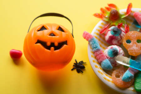 halloween candies seen close up on yellow backgroundの写真素材