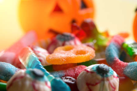 halloween candies with orange pumpkin in the backgroundの写真素材