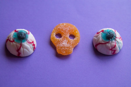 halloween candies seen close up on purple backgroundの写真素材
