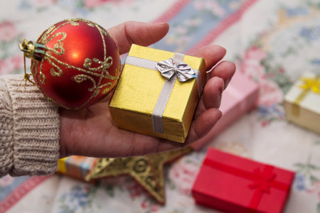 Woman holding Christmas decorations, Christmas greetingの写真素材