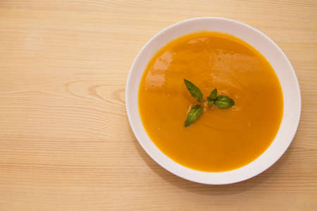 bowl with pumpkin soup on backgroundの写真素材