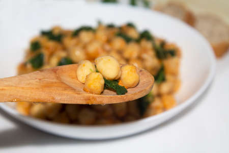 bowl of cooked chickpeas with spinach closeup viewの写真素材