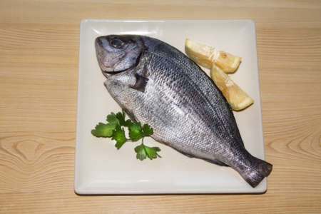 fresh fish with lemon and parsleyの写真素材