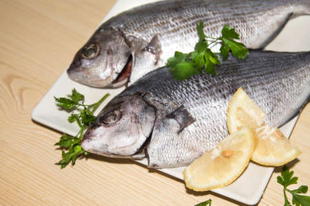 fresh fish with lemon and parsleyの写真素材