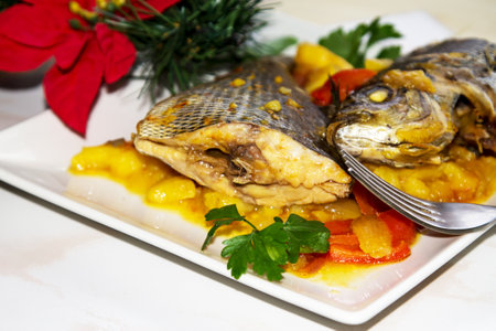 Roasted fish with potatoes for dinner or lunch at Christmas or New Yearの写真素材