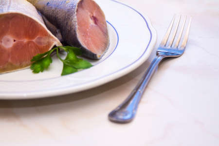 fresh fish, salmon tails on the plateの写真素材