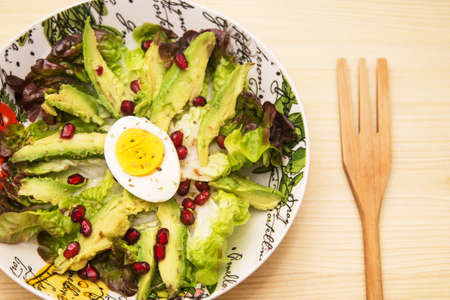 bowl with avocado lettuce and pomegranateの写真素材