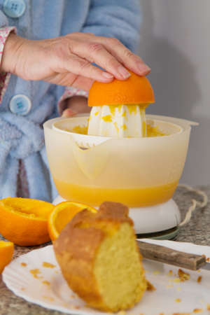 Woman making orange juice in the kitchen