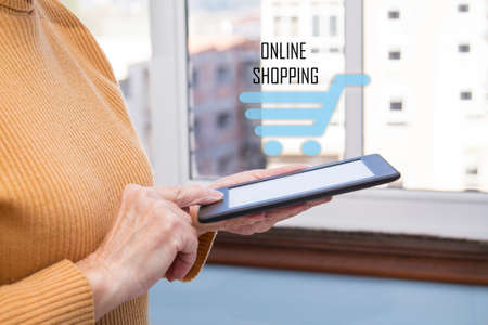 Woman shopping online by using ipad at home. Easy free style shopping online.の写真素材