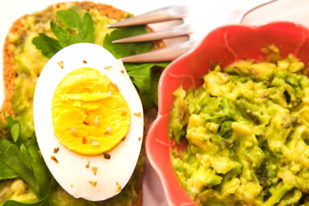 Guacamole toast and hard boiled egg with parsleyの写真素材
