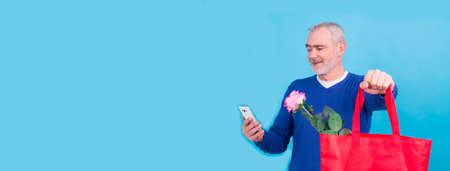 man doing online shopping on valentines day mobile phoneの写真素材