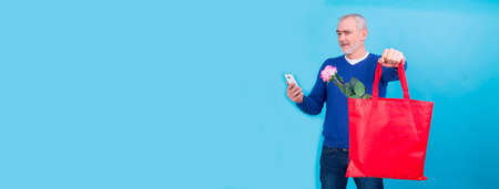 man doing online shopping on valentines day mobile phoneの写真素材