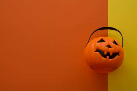 pumpkin shaped basket with colorful background, halloween conceptの写真素材