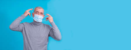 senior man with disposable medical mask on his face in prevention of virus and infectionの写真素材