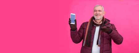 senior man showing mobile or smart phoneの写真素材
