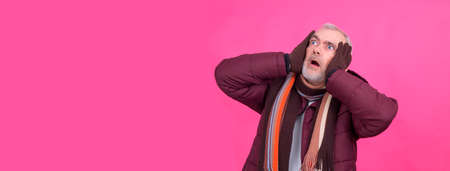 frustrated man in coat and scarfの写真素材