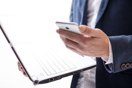 businessman with laptop and cellphoneの写真素材