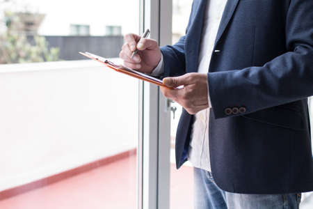 businessman signing documents in the office, real estate and mortgage conceptの写真素材