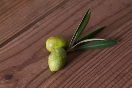 olives with branch on woodの写真素材
