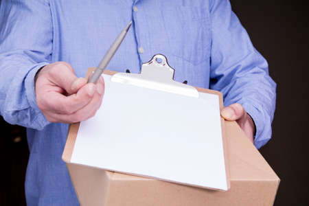 person delivers package to home with delivery note to sign. Friendly worker, high quality delivery...