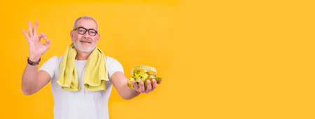 attractive man with scale and tape measure, diet and health conceptの写真素材