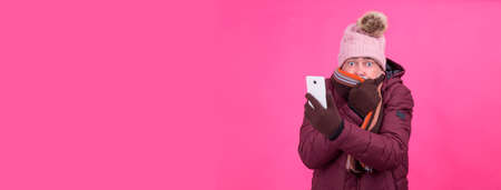 cold senior man with mobile phoneの写真素材