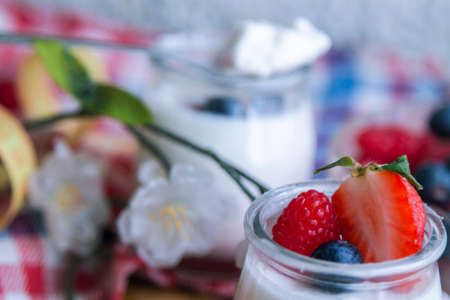 natural yogurt with strawberries and blueberries, concept of diet and healthの写真素材