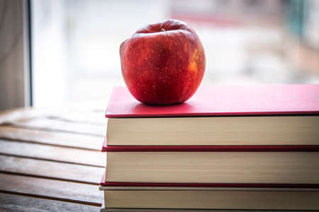 back to school concept. book with apple on the tableの写真素材