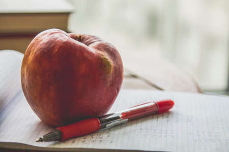 back to school concept. book with apple on the tableの写真素材