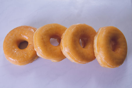 delicious sugary donuts on marbled white backgroundの写真素材