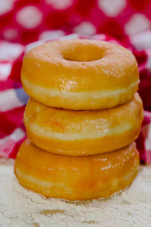 cup with teaspoon and delicious donutの写真素材