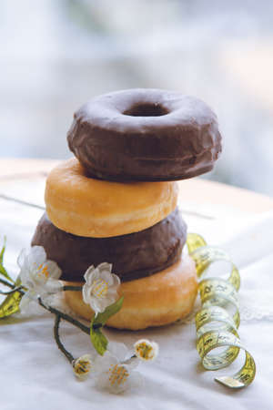 cup with teaspoon and delicious donutの写真素材