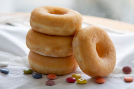 cup with teaspoon and delicious donutの写真素材