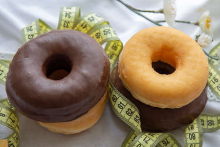 cup with teaspoon and delicious donut