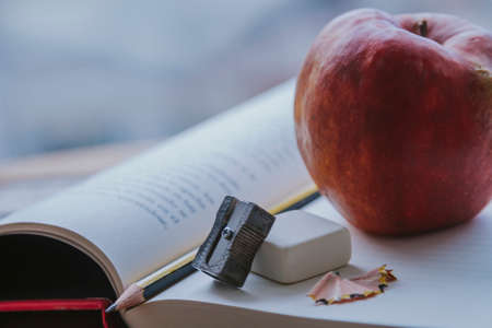 books, pencil sharpener, pencil and eraser on the table, back to school conceptの写真素材