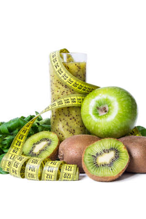 Organic fruit and vegetable juice or smoothie with measuring tapeの写真素材