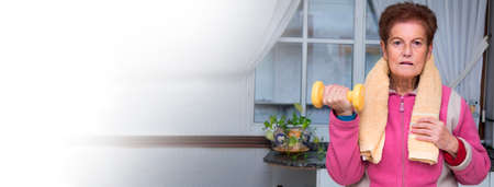 Portrait of senior woman exercising with dumbbellsの写真素材