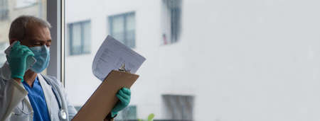 doctor using mobile phone to give results of analysis and testsの写真素材